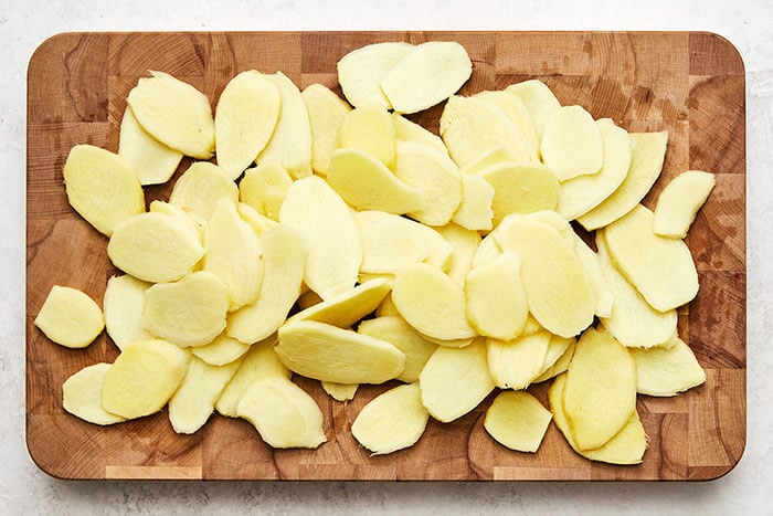 Sliced ginger on a wooden board