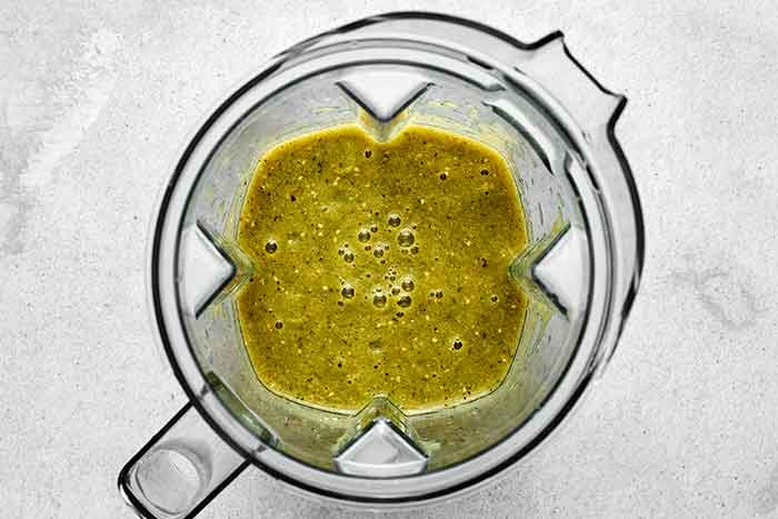 Blending salsa verde in a blender.