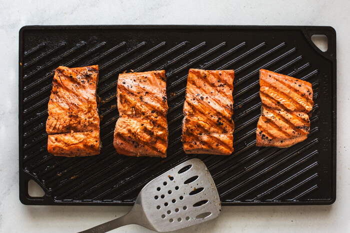 Grilling salmon fillets on a grill