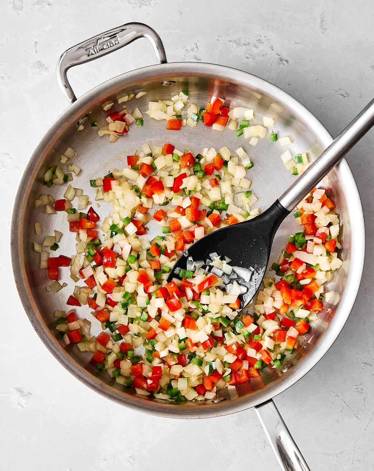 Cooking veggies in a pan for Mexican rice.