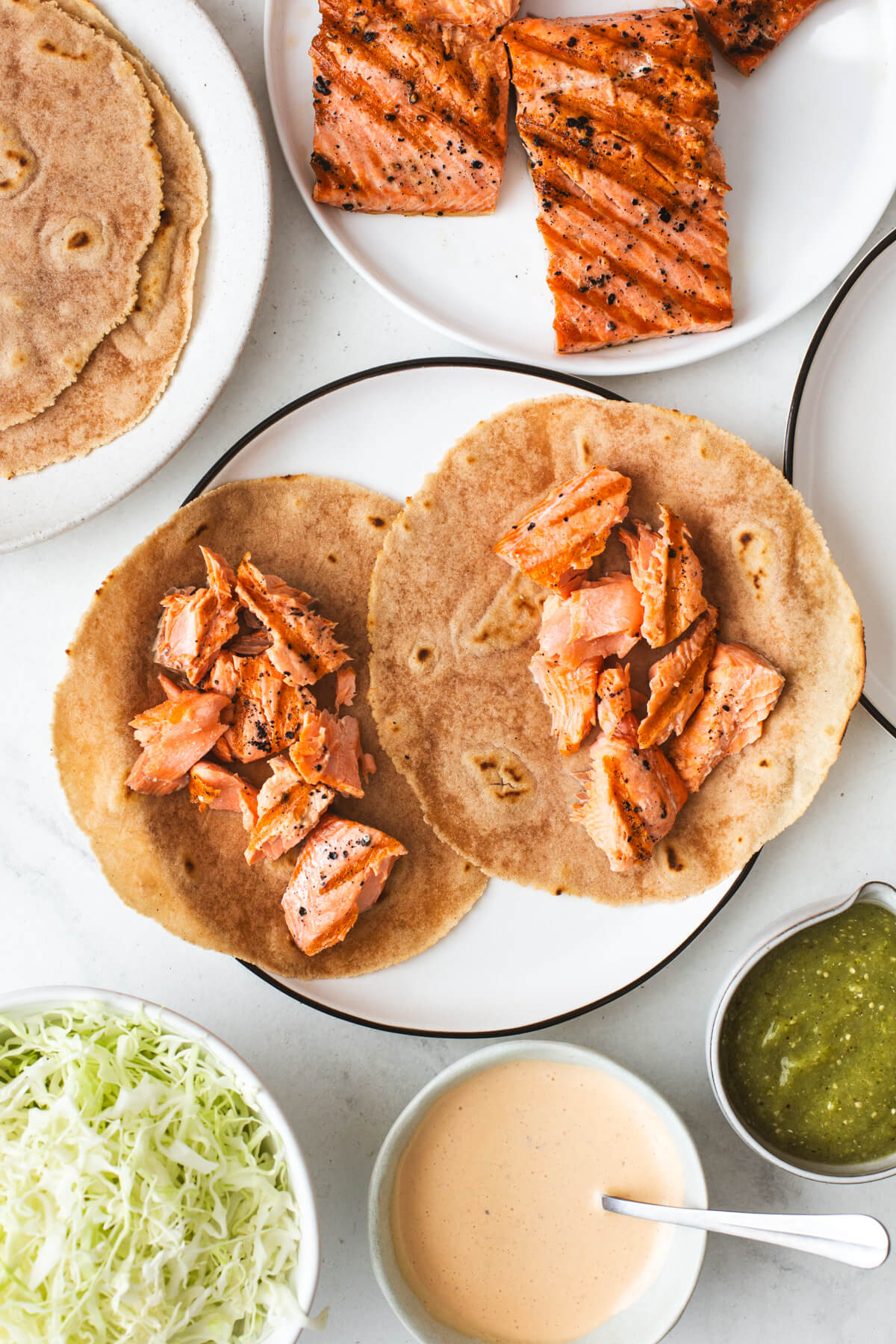 Prepping salmon tacos on a plate