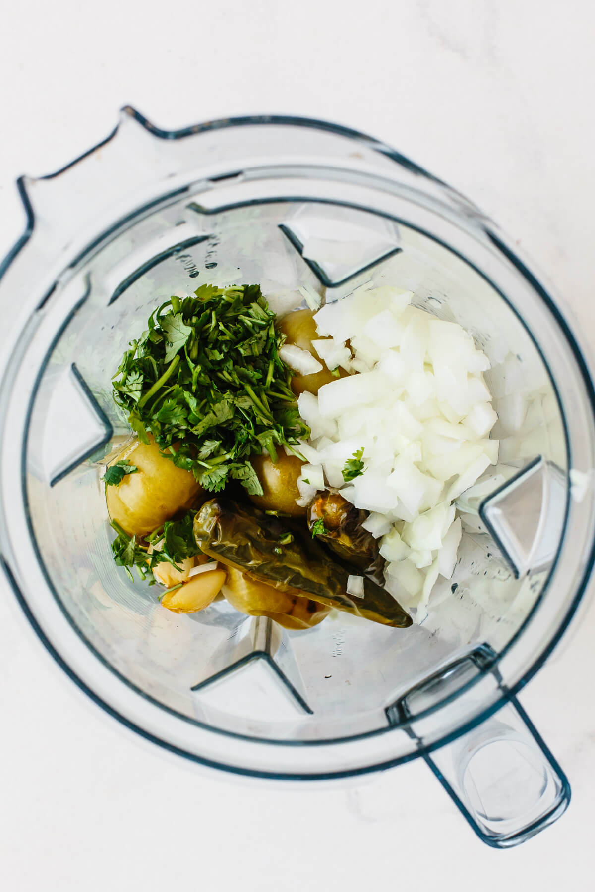 Add a spicy, flavorful kick to any Mexican dish with this homemade salsa verde (tomatillo salsa)! All you need is to roast, blend, and serve. Salsa verde ingredients in a blender