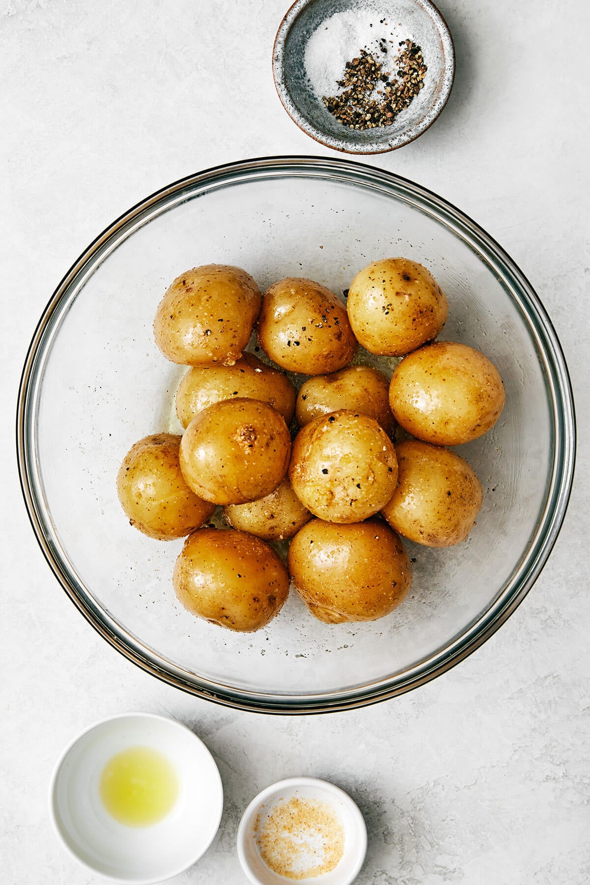 Seasoning little potatoes in a bowl