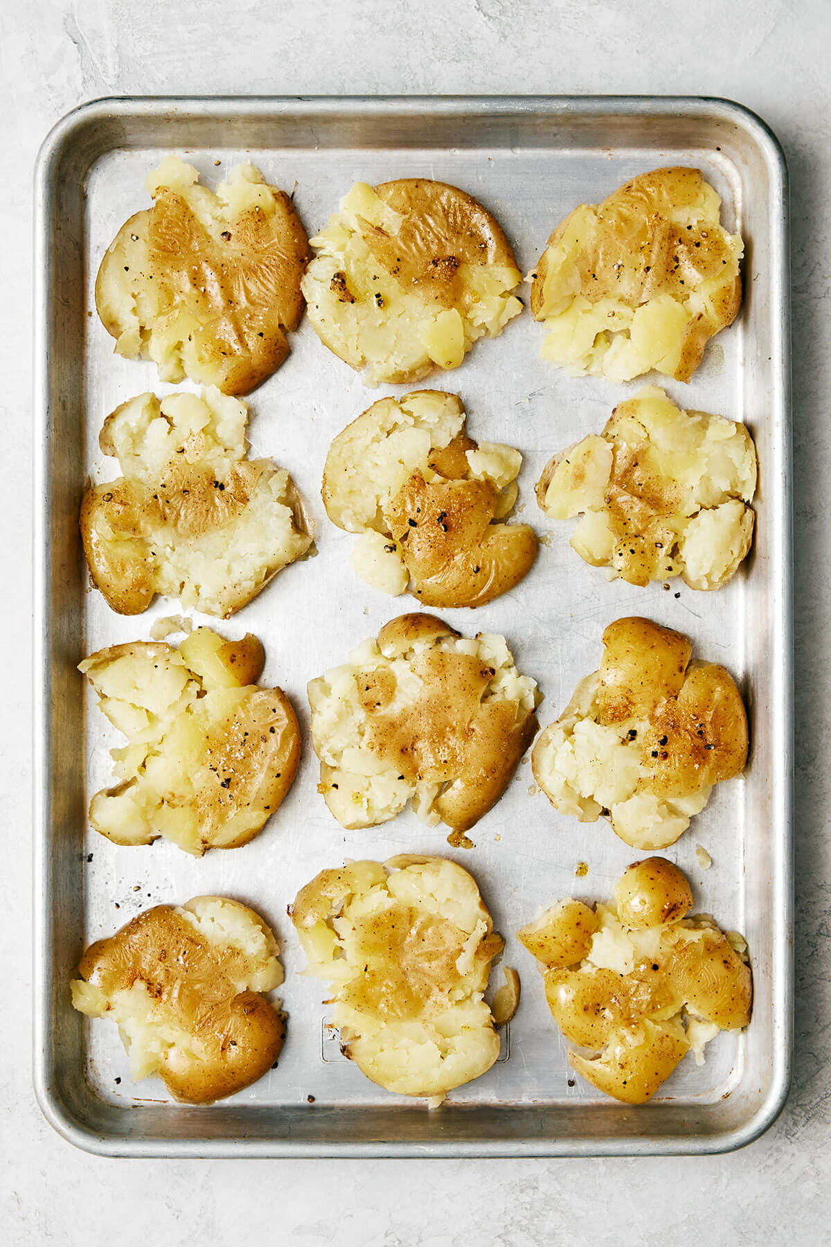 A sheet pan of smashed potatoes