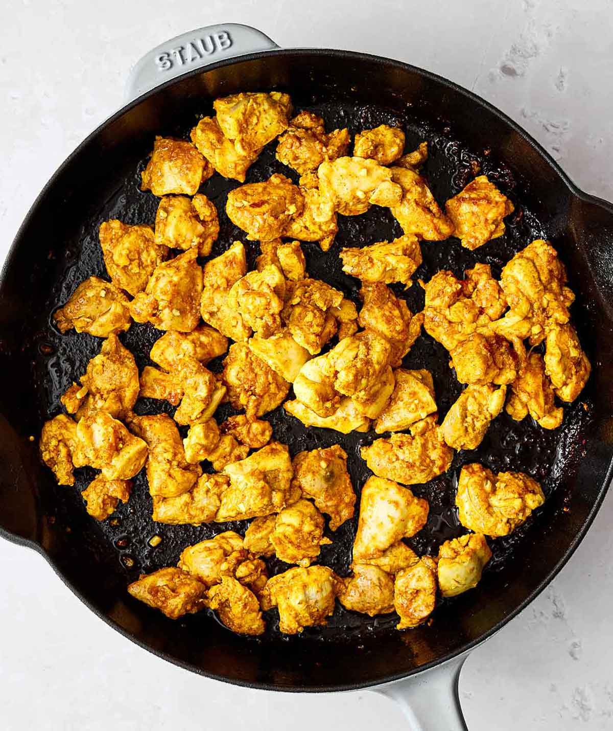 Step two: Cooking spiced chicken in a pan.