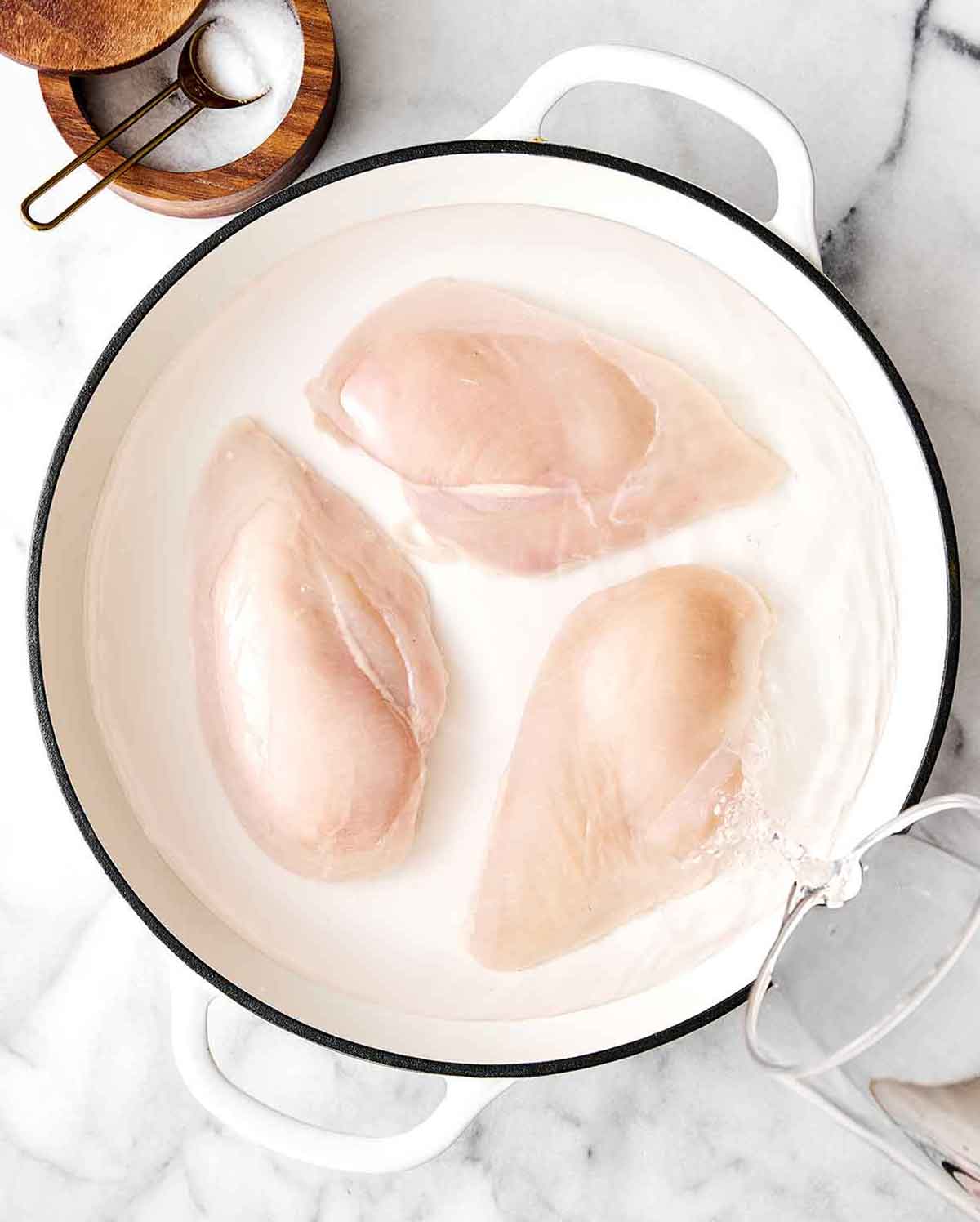 Step one of chicken salad: poach chicken.