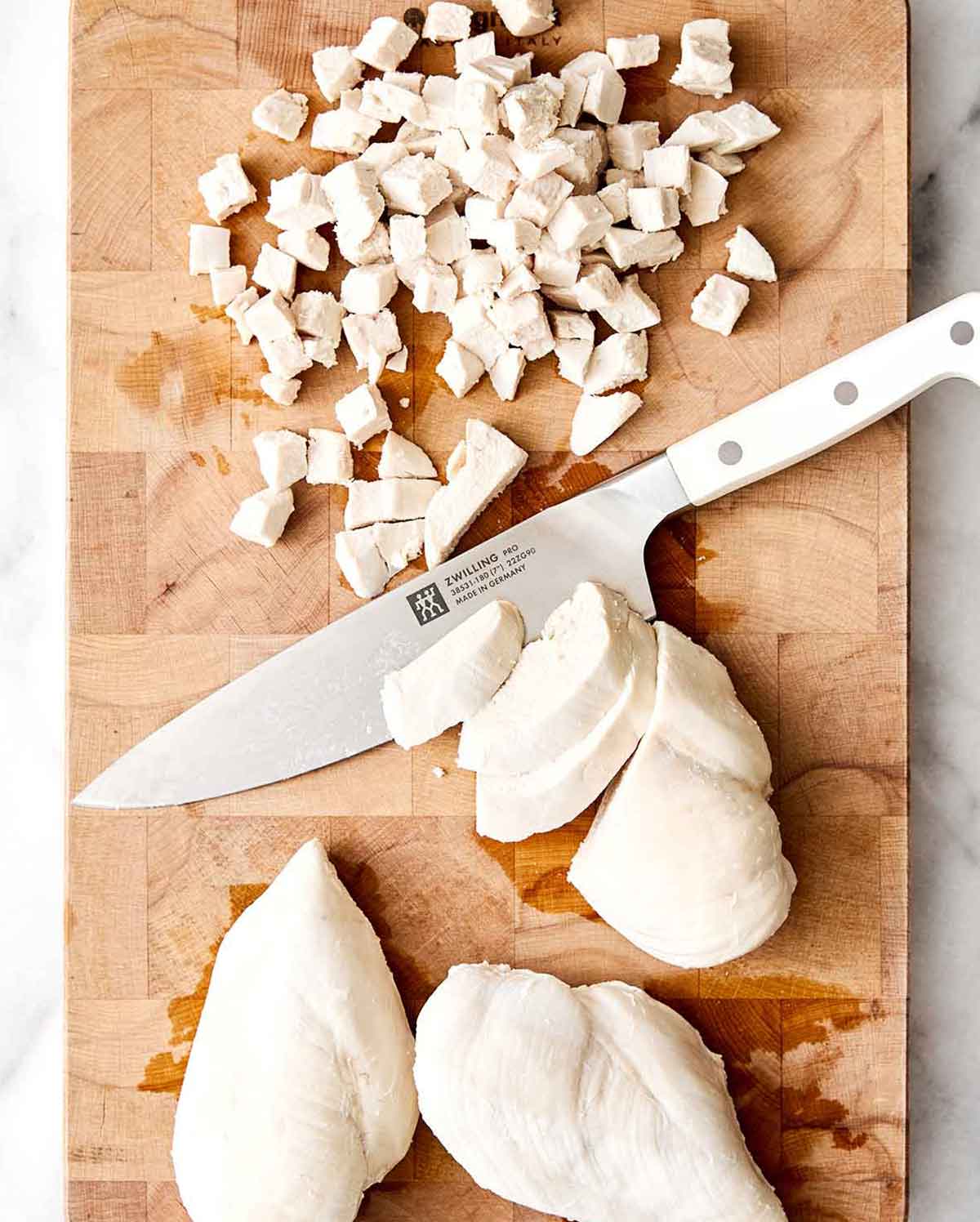 Step three of chicken salad: dice chicken.