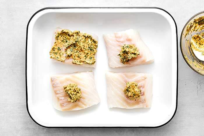 Step three of baked cod: add the butter mixture on top.