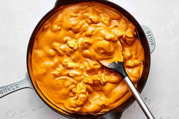 Step five: Adding the chicken back into the curry sauce.