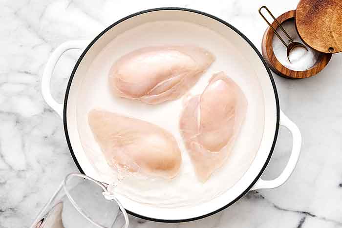 Step one of chicken salad: poach chicken.