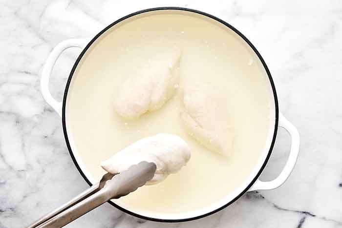 Step two of chicken salad: take poached chicken out.