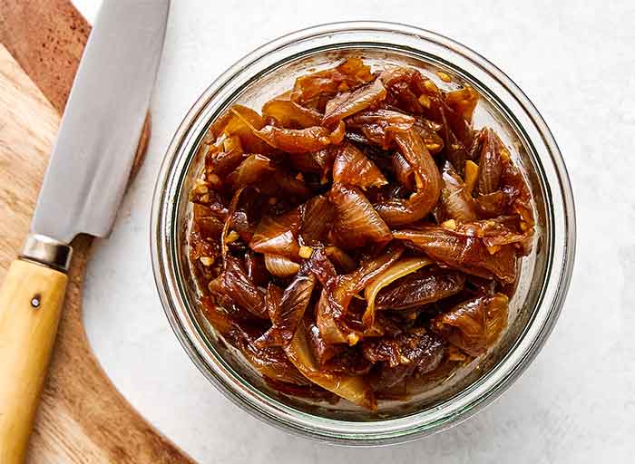 Step four of French onion dip: cool and chop the onions.