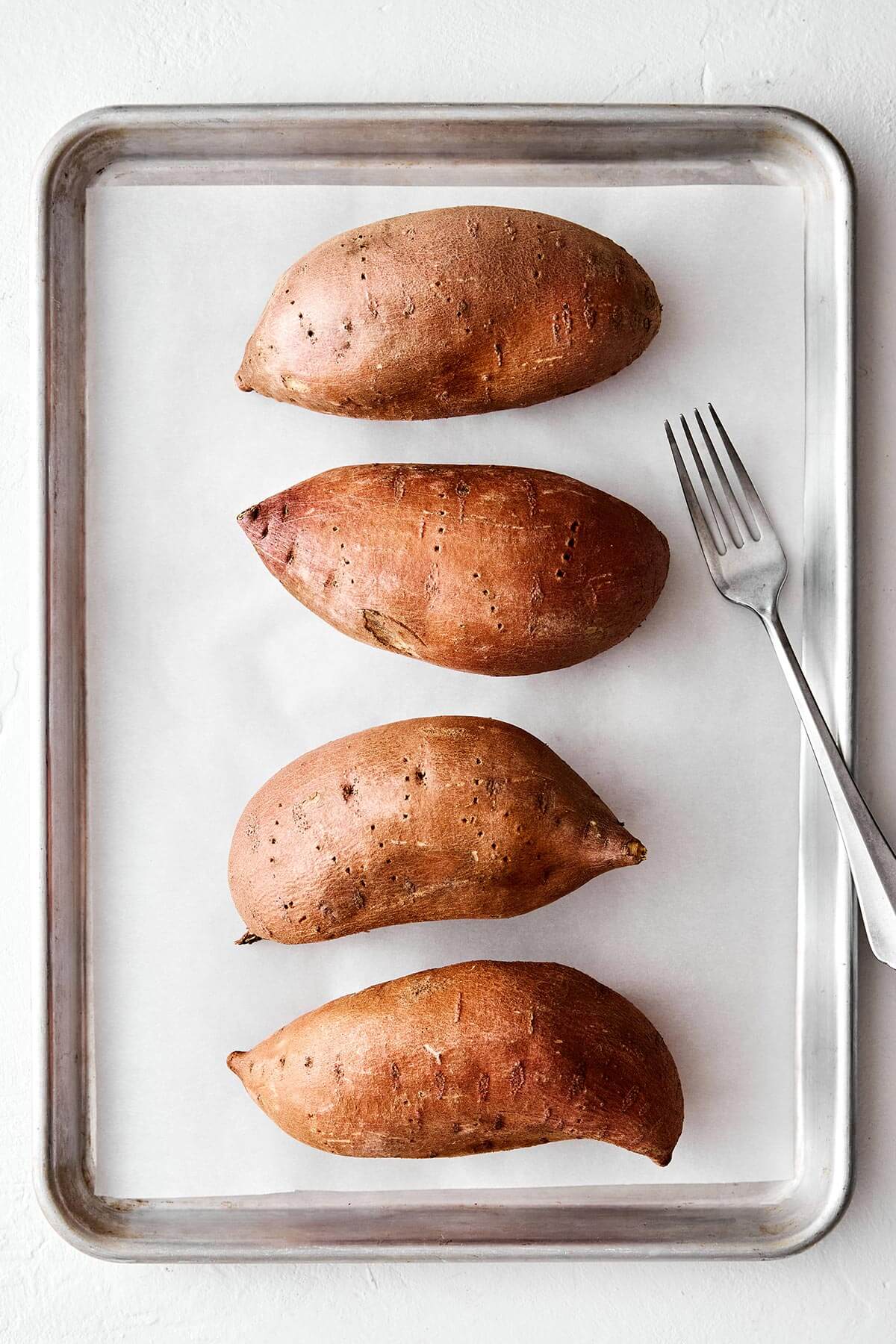 Sweet potatoes poked with a fork.