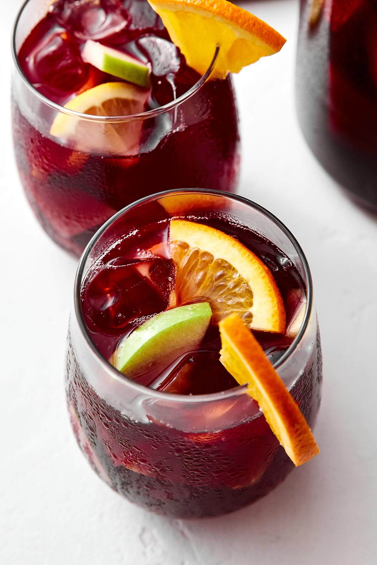 A pitcher of this red sangria feels is the perfect cocktail for a crowd! All you need is Spanish red wine, brandy, and fresh fruit. Glasses of red sangria.