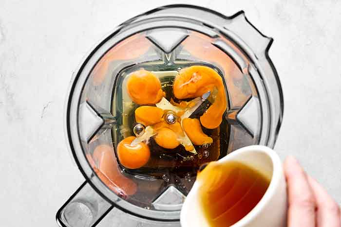 Step one of making eggnog: tempering eggs in a blender.