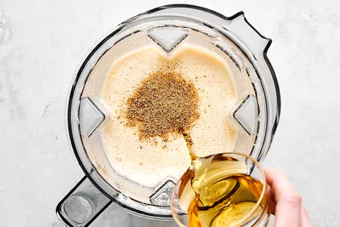 Step two of making eggnog: blending in alcohol.