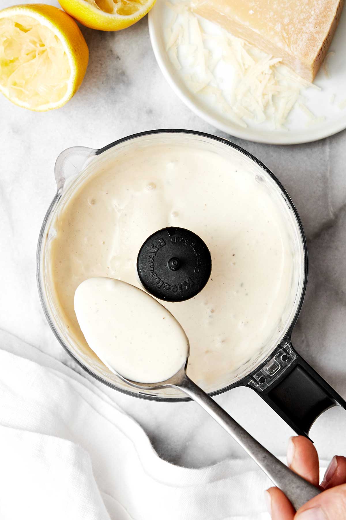 Creamy Caesar dressing in a food processor.