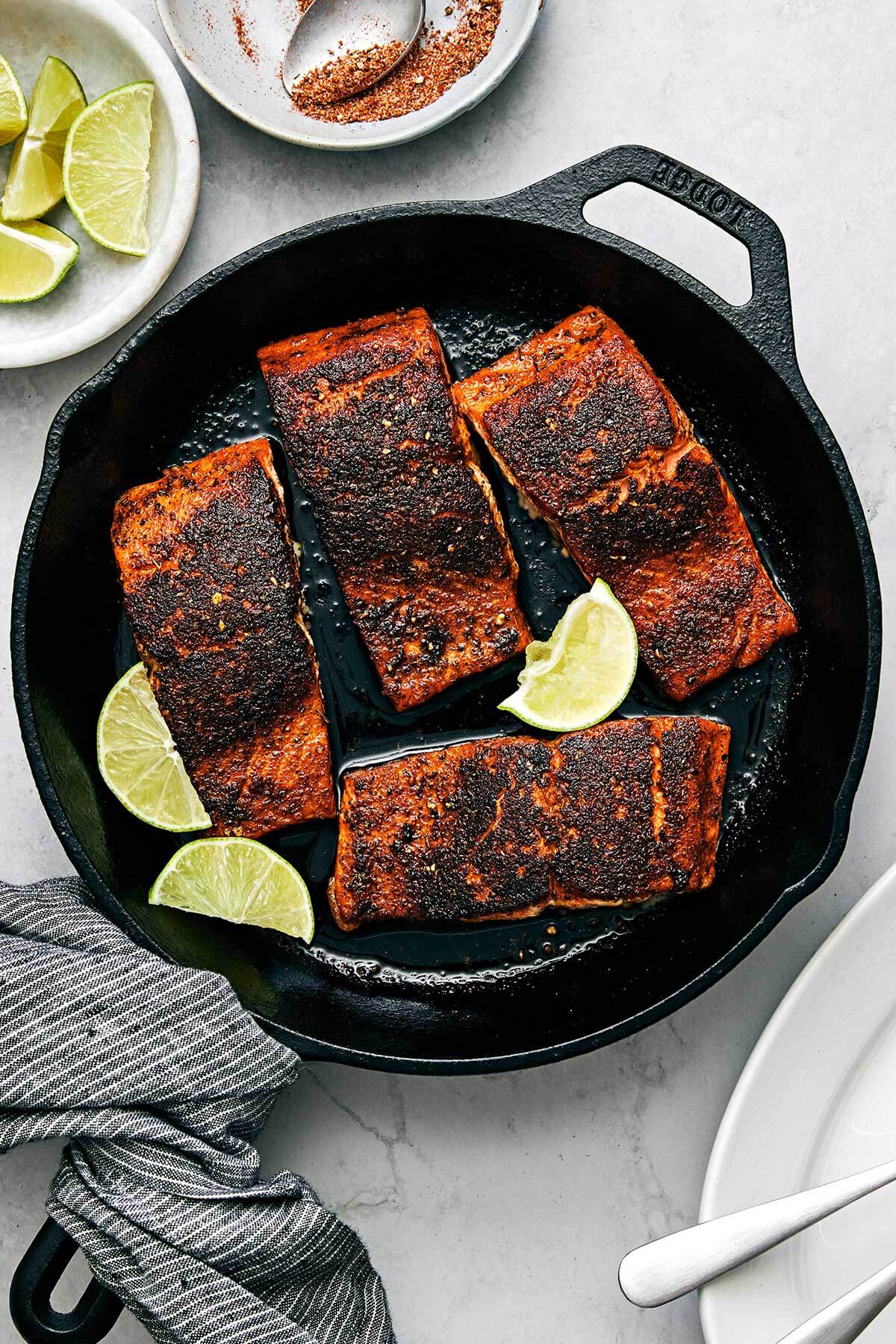 Blackened salmon in a skillet.