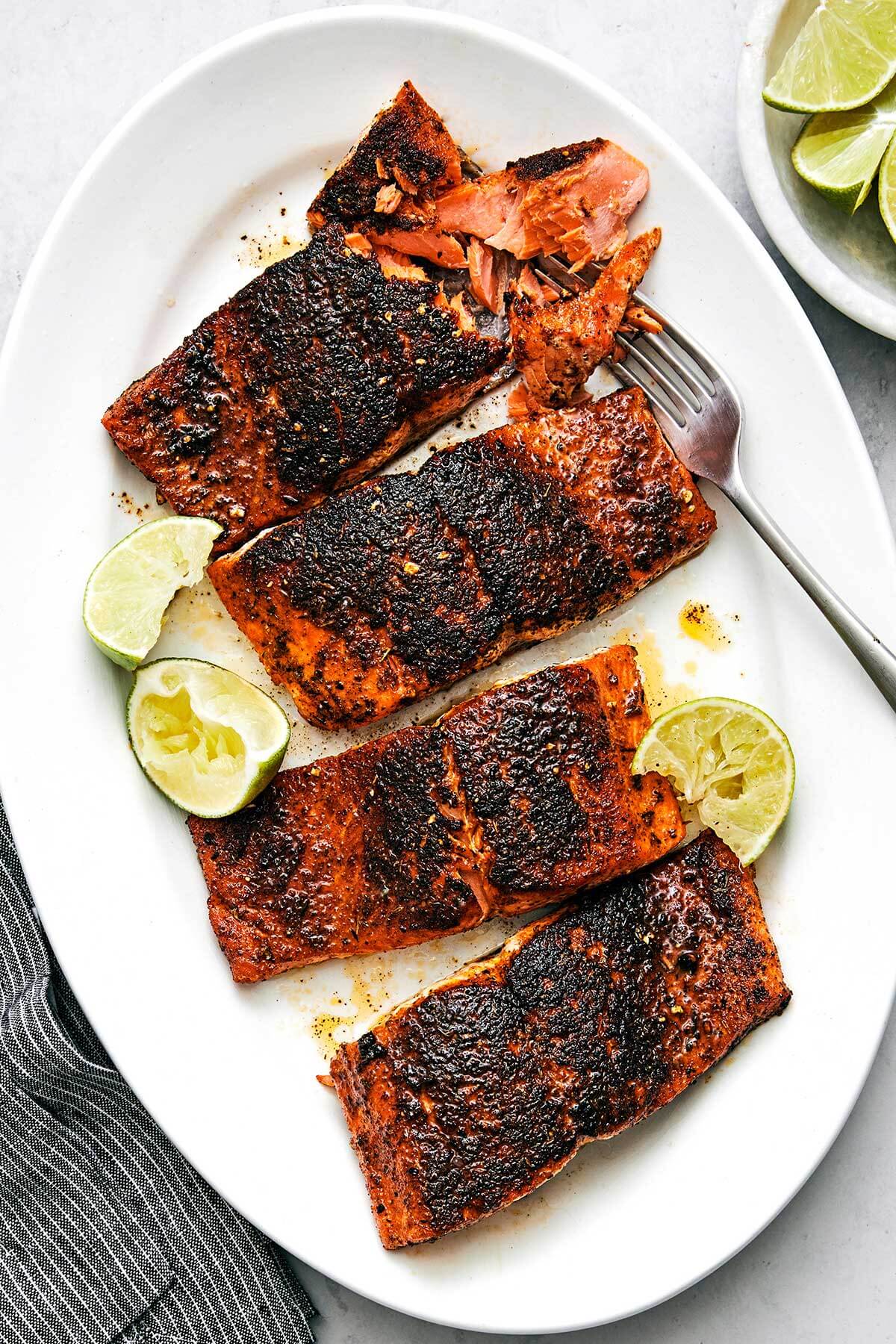 Blackened salmon on a white plate.