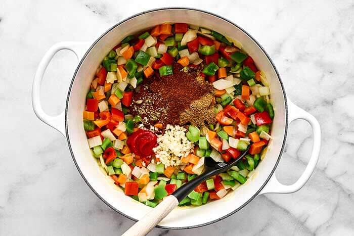 Cooking vegetarian chili in a white pot.