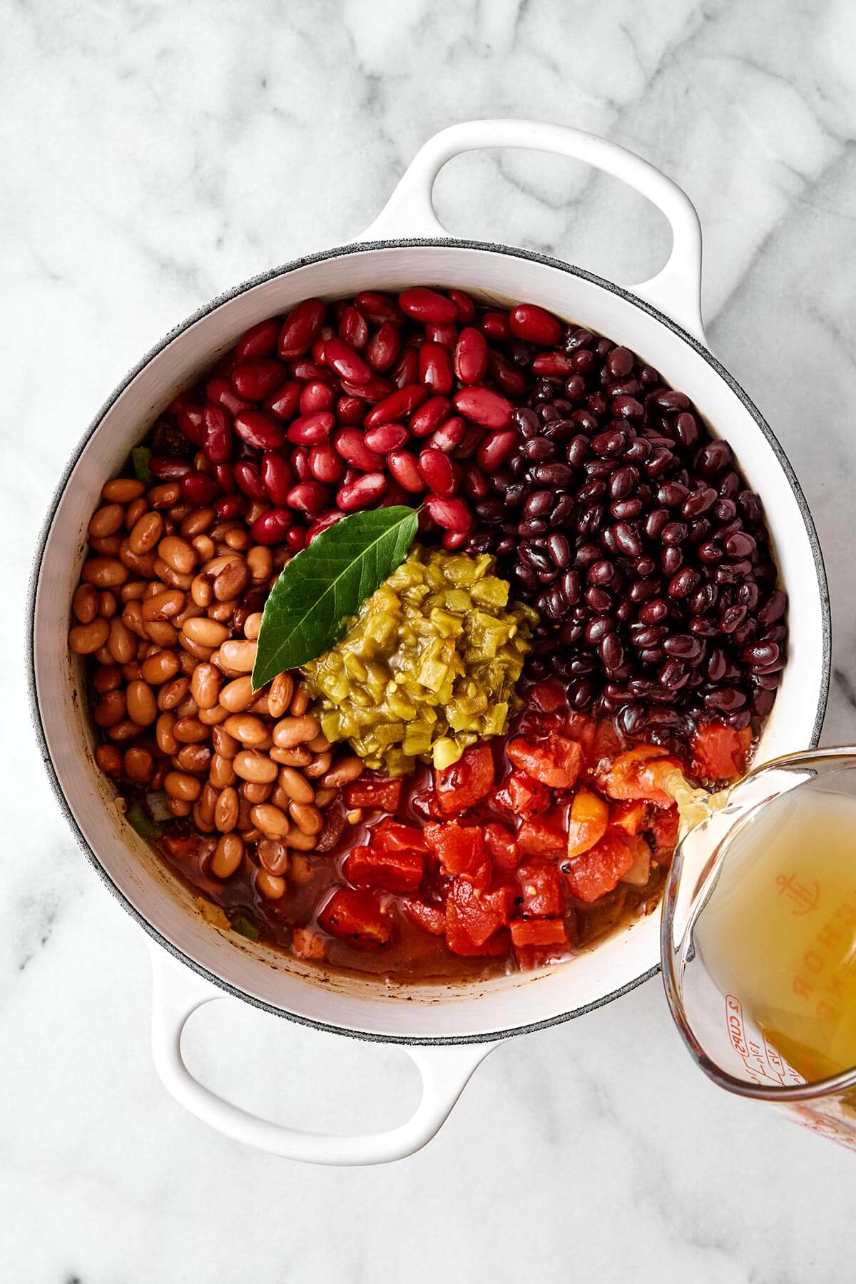 This vegetarian chili is a top-notch meatless dinner with layers of good-for-you vegetables, hearty beans, and warming spices! Making vegetarian chili in a pot.