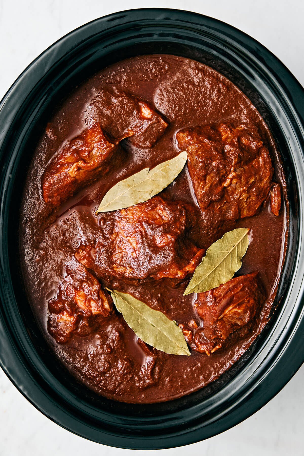 Mexican birria de res is a hearty slow-cooked stew with the utmost flavor and juicy, tender beef. Serve it as is or make birria tacos! Birria de res in a crockpot.