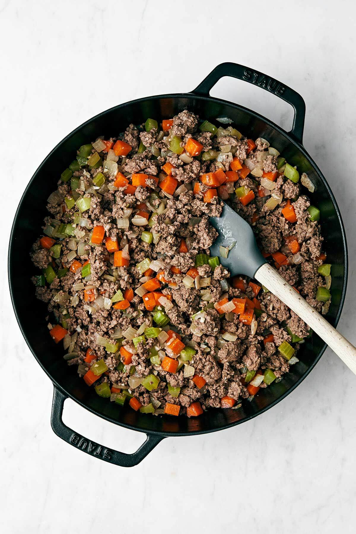 Cooked cottage pie filling in a pan.