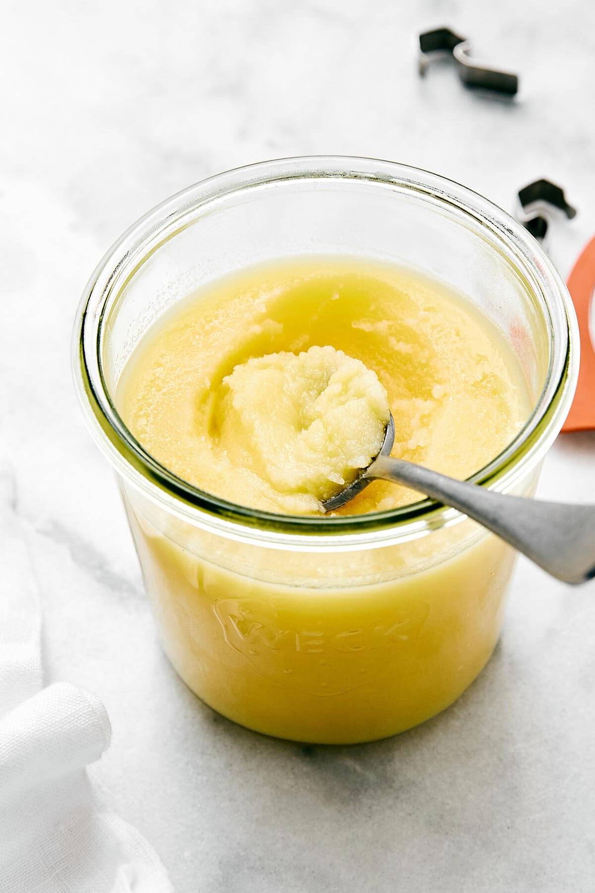 Homemade ghee (clarified butter) is incredibly easy to make, much cheaper than store-bought versions, and is perfect for those who are dairy-sensitive. Ghee in a glass jar.