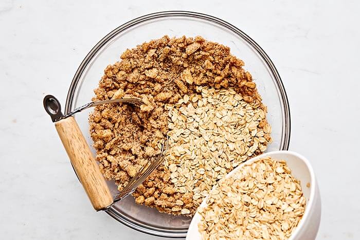 Cutting butter into an oat crumble.