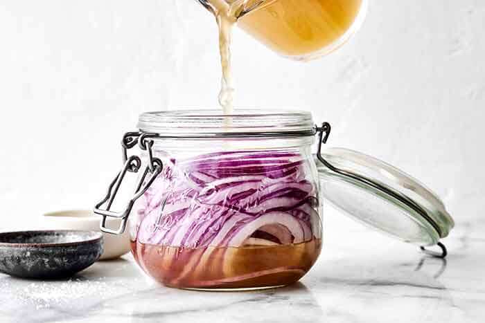Making quick pickled onions in a jar.