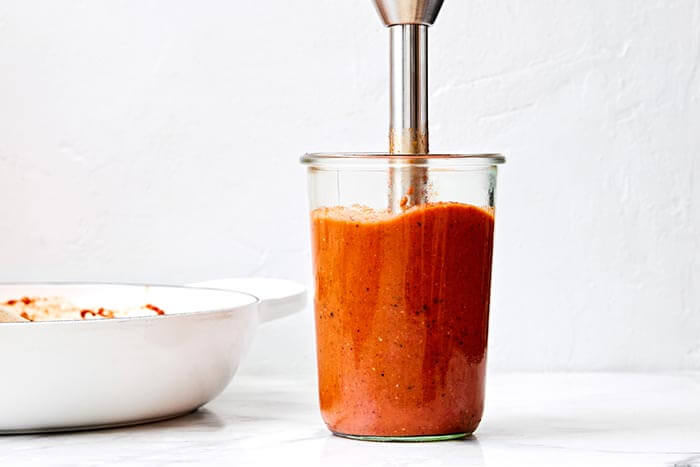 Blending sauce with immersion blender.