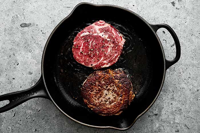Searing ribeye steaks.