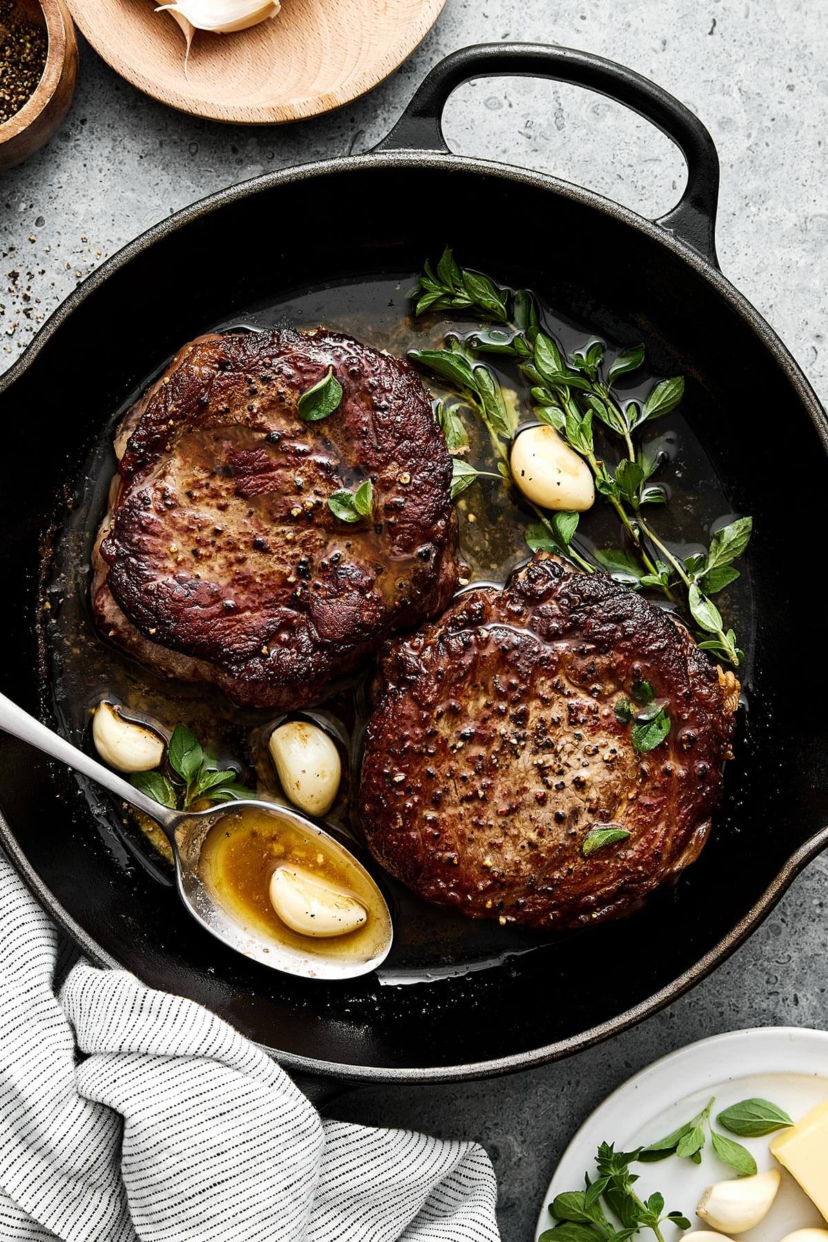Seared ribeye steak in a cast iron pan.
