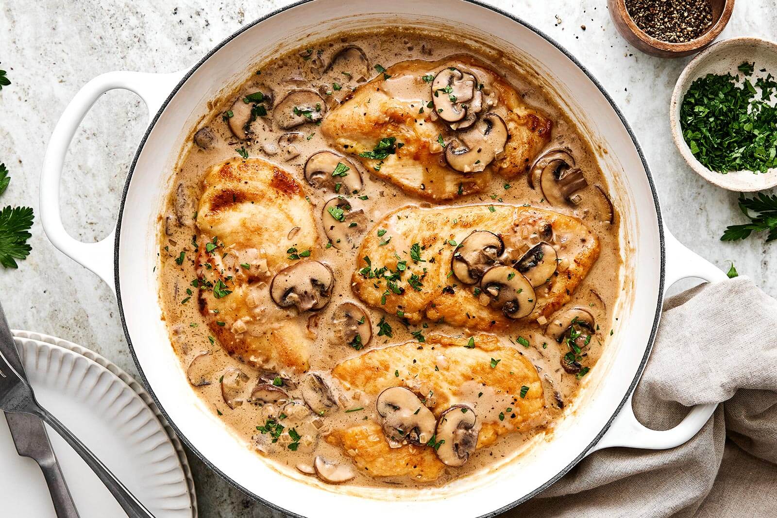 A white pan with chicken Marsala.