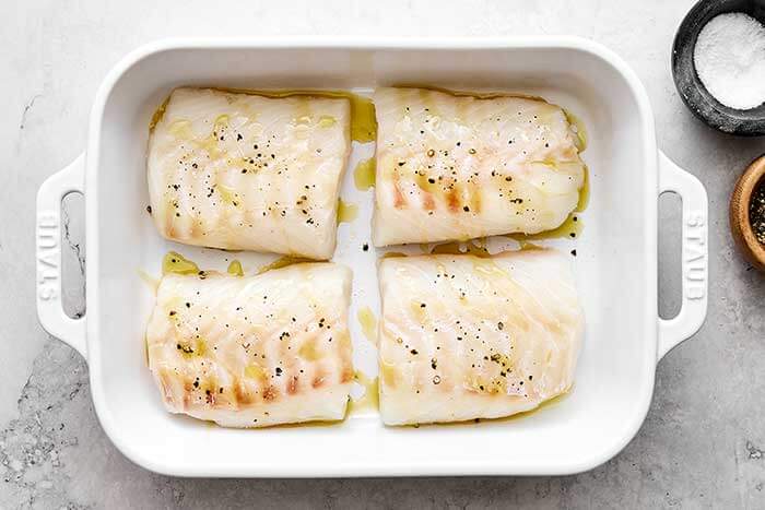 Cod filets in a baking dish.