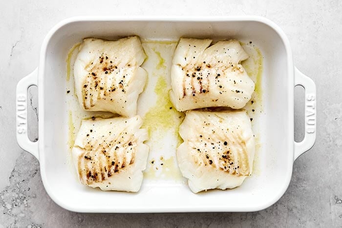 Baked cod filets in a baking dish.