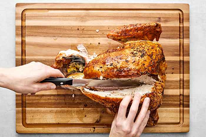 Step two of how to carve a turkey: remove the breasts.