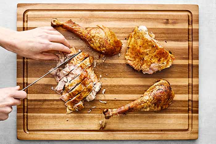 Step six of how to carve a turkey: carve the final pieces.