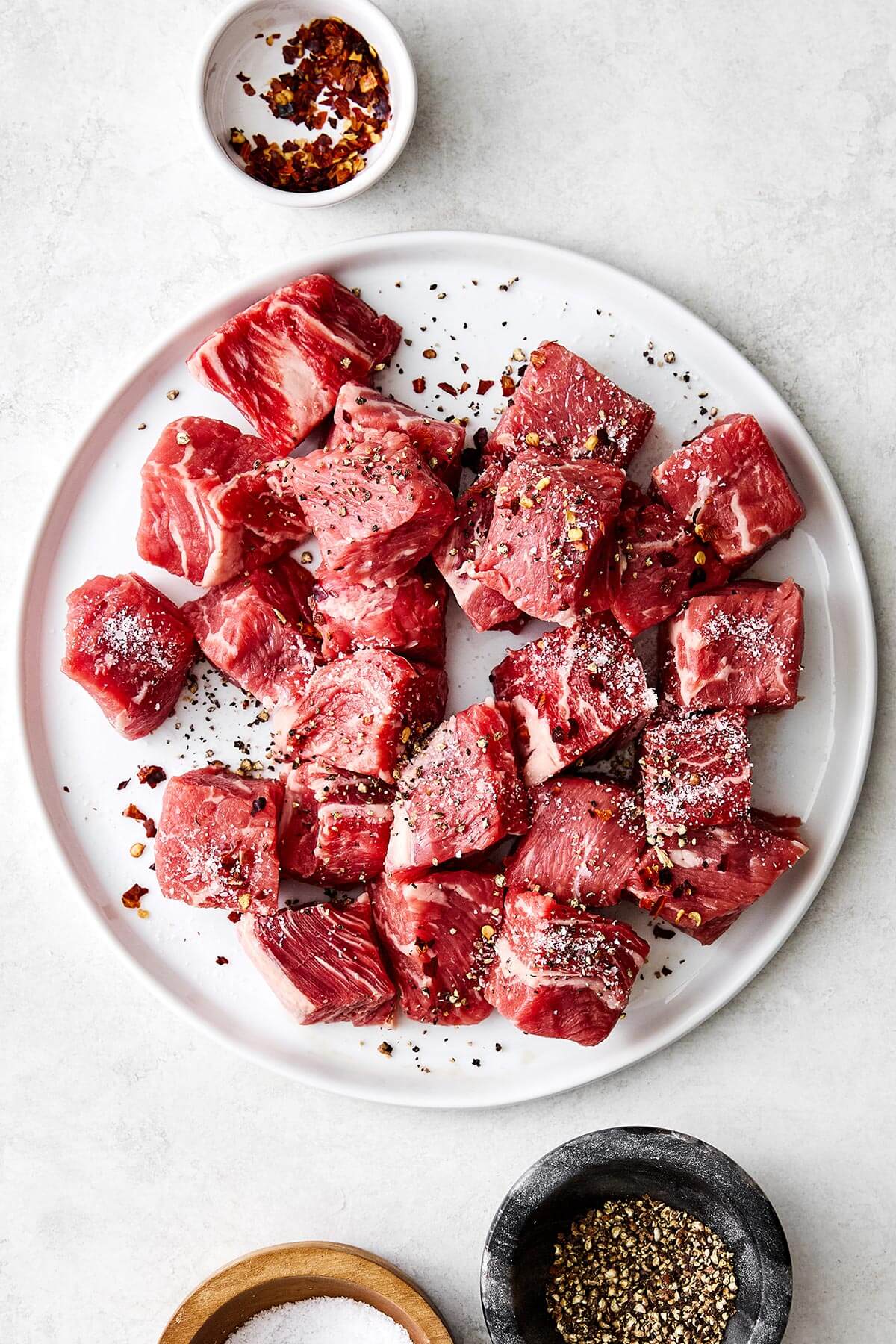 Seasoned steak bites on a plate.