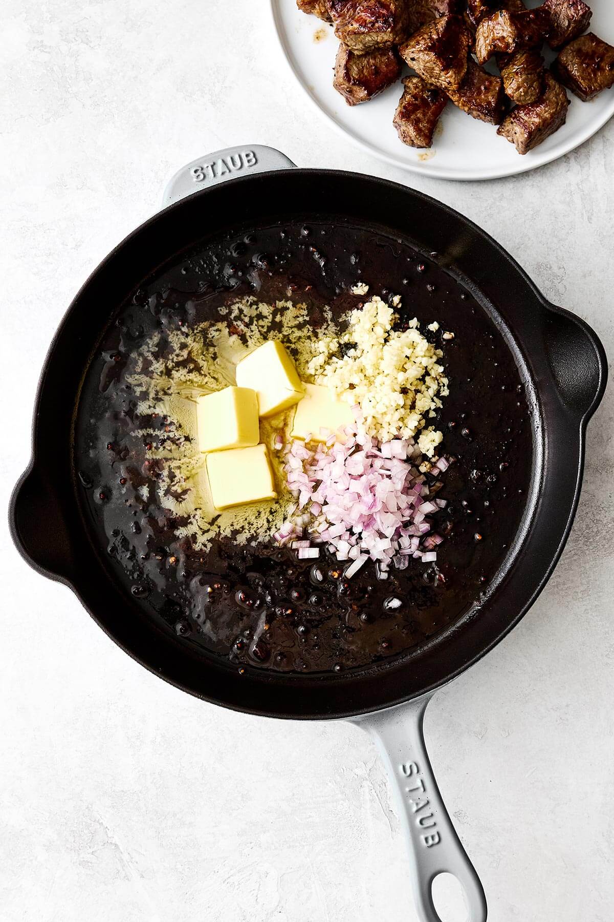 Butter and shallots in a pan.