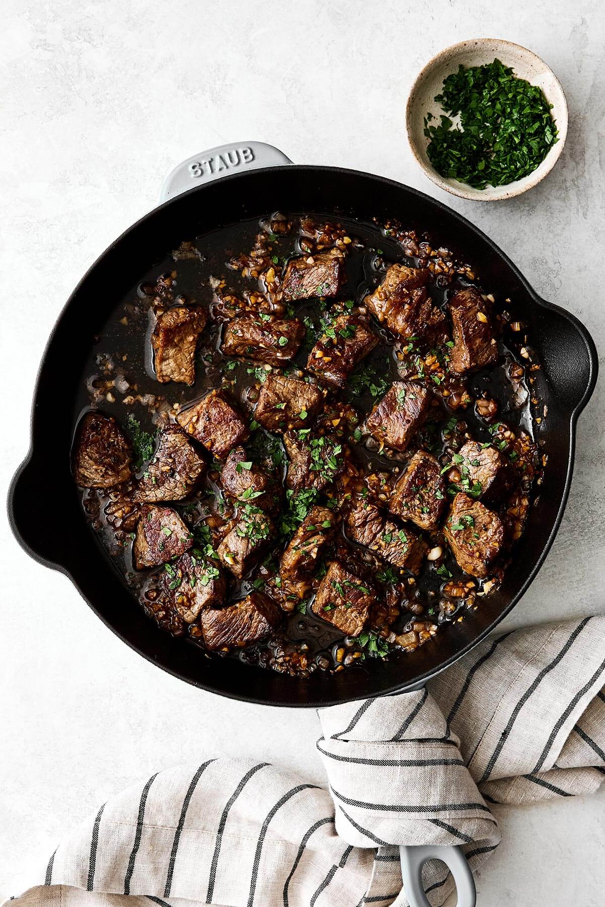 Garlic butter steak bites in a pan.