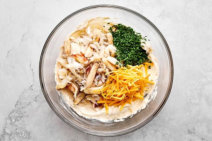 Crab dip ingredients in a glass bowl.