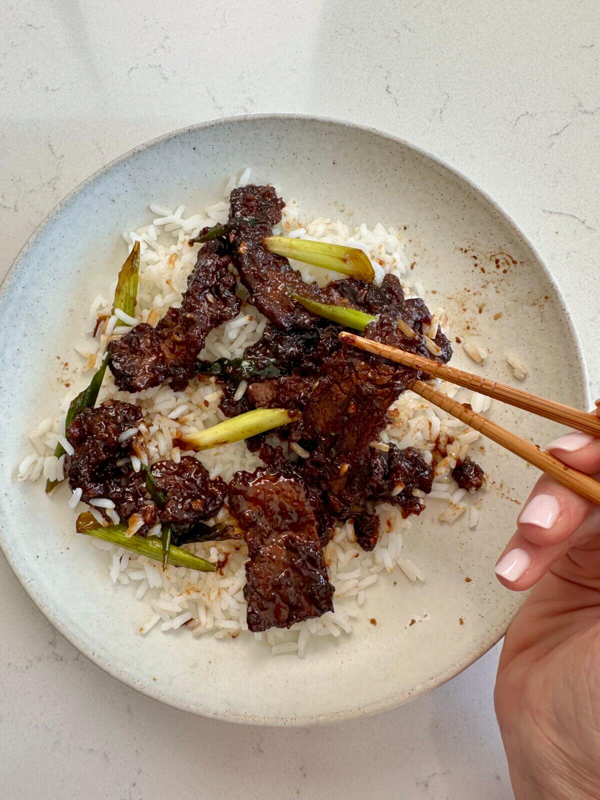 Mongolian beef on a plate with rice.