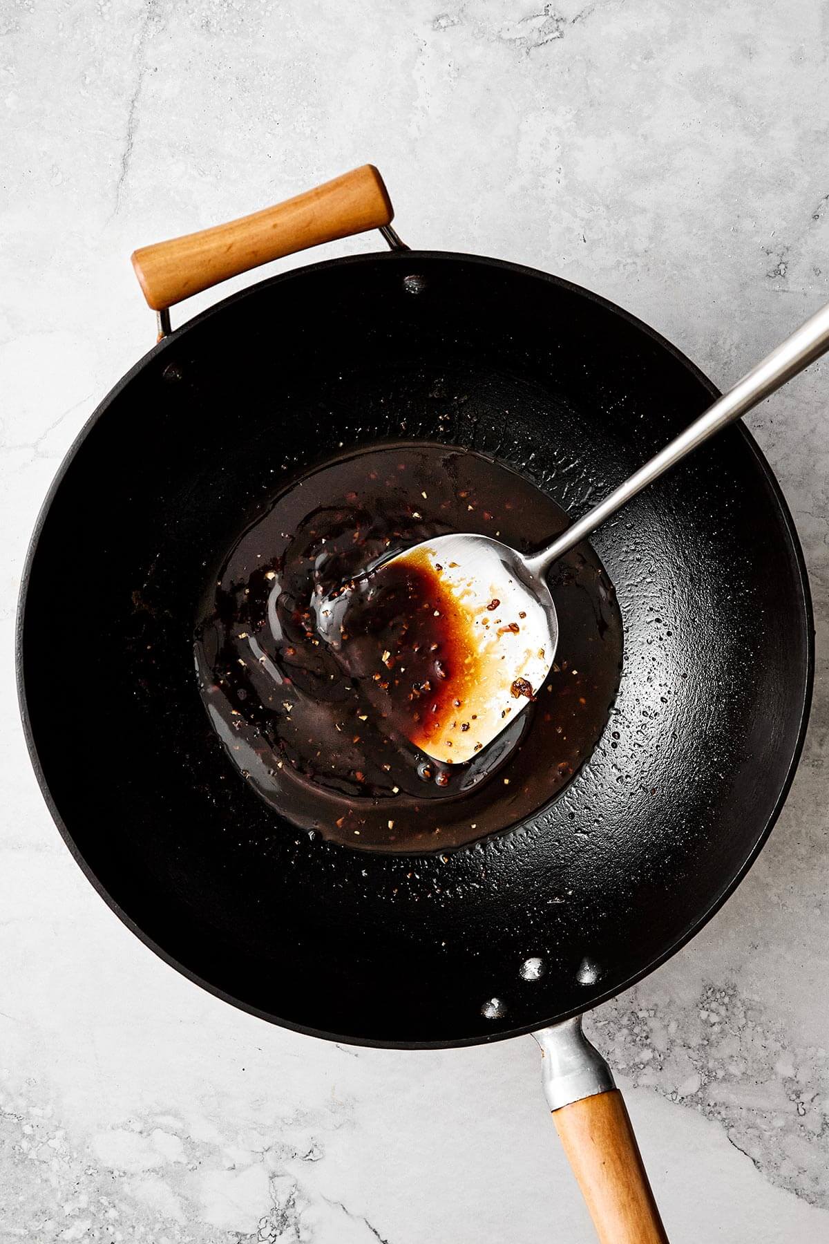 Cooking Mongolian beef sauce in a wok.