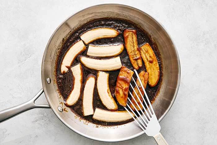 Caramelized bananas in a pan.