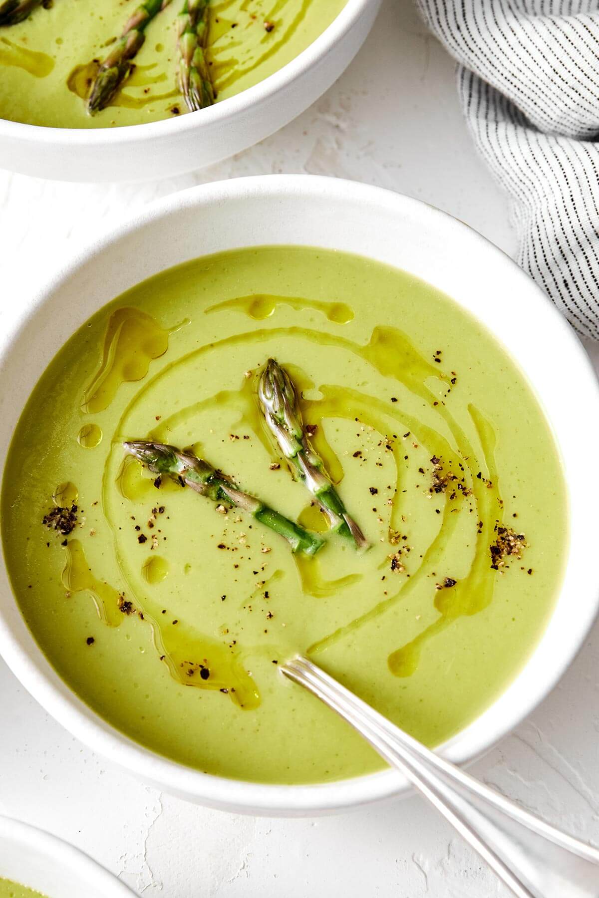 Creamy asparagus soup in a bowl.