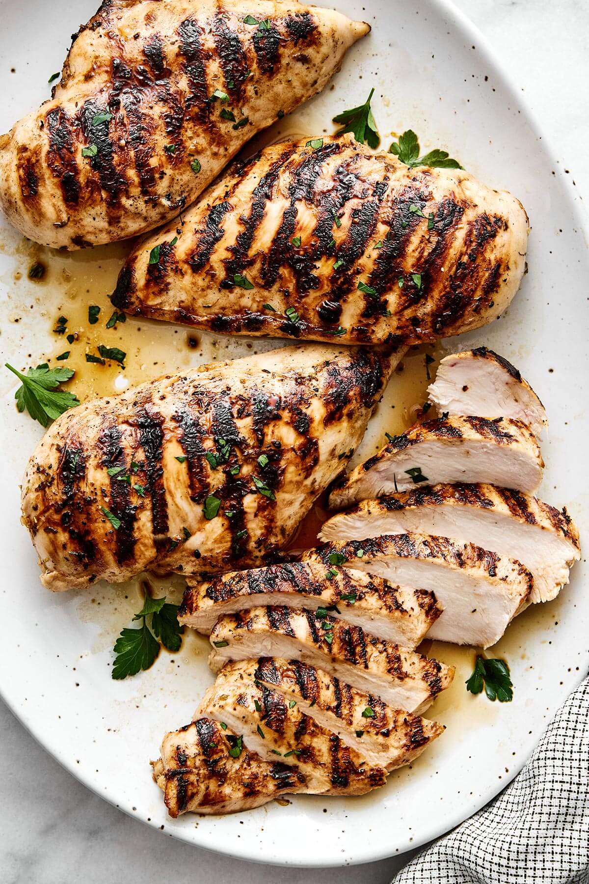 Sliced grilled chicken on a plate.