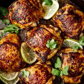 Cilantro lime chicken thighs with lime slices.