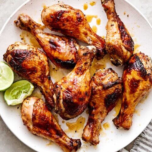 Baked hot honey chicken drumsticks on a plate.