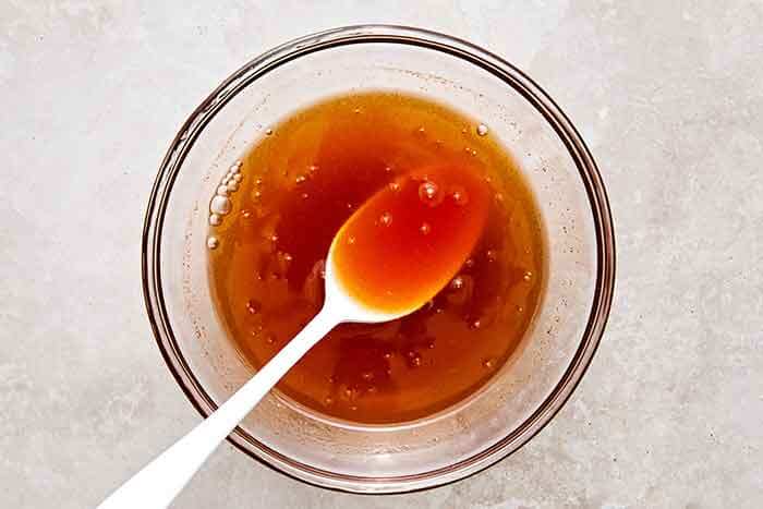 Hot honey sauce in a glass bowl.